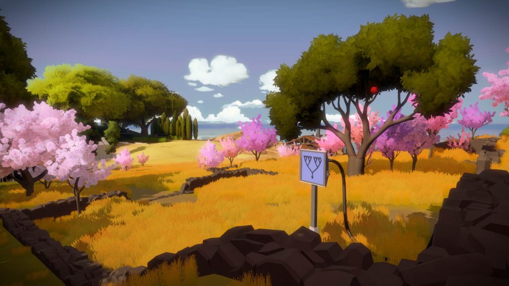 a screenshot from the game, The Witness, showing a strange sign in a colorful meadow with trees scattered about and a blue sky sprinkled with white clouds.